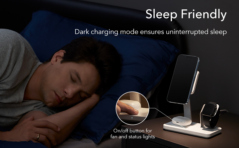 Man charging iPhone on a sleep mode wireless charging stand in bed side table